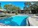 Community pool with clean, blue water and surrounding landscaping at 5649 Summerside Ln # 41B, Sarasota, FL 34231
