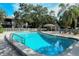 Sparkling community pool with blue water surrounded by lush landscaping at 5649 Summerside Ln # 41B, Sarasota, FL 34231