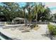 Community pool featuring lounge chairs, palm trees, shade and paved brick flooring at 5649 Summerside Ln # 41B, Sarasota, FL 34231