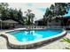 Serene community pool with lush landscaping and a nearby clubhouse at 5649 Summerside Ln # 41B, Sarasota, FL 34231