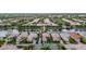 Aerial view of upscale homes, featuring meticulously landscaped yards, tile roofs, and serene lake views at 5751 Wilena Pl, Sarasota, FL 34238