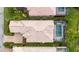 Stunning aerial view showcasing the home's pool, tiled roof, and meticulously landscaped backyard at 5751 Wilena Pl, Sarasota, FL 34238
