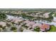 Scenic aerial view of homes nestled among lush landscaping and a tranquil lake with bridges, creating a peaceful community at 5751 Wilena Pl, Sarasota, FL 34238