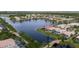 Expansive aerial view of homes surrounding a lake, highlighting community bridges and lush landscaping at 5751 Wilena Pl, Sarasota, FL 34238