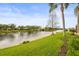 Picturesque view of backyard with waterfront access and community landscaping at 5751 Wilena Pl, Sarasota, FL 34238