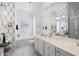 Elegant bathroom featuring a bathtub, dual sinks, shower, and blue and white patterned wallpaper at 5751 Wilena Pl, Sarasota, FL 34238