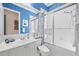 Bright bathroom featuring blue accents, a glass-enclosed shower, and a vanity with ample counter space at 5751 Wilena Pl, Sarasota, FL 34238