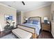 Spacious bedroom featuring a ceiling fan, bench seat, a patterned rug, and neutral wall color at 5751 Wilena Pl, Sarasota, FL 34238