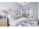Comfortable bedroom with blue floral bedding, bamboo-style bed frame, and a mirrored closet at 5751 Wilena Pl, Sarasota, FL 34238