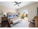 Comfortable bedroom with a ceiling fan, wood floors, bench seat, and access to an outdoor patio at 5751 Wilena Pl, Sarasota, FL 34238