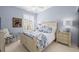 Cozy bedroom features blue floral bedding, an off-white bamboo-style bed frame, and plantation shutters at 5751 Wilena Pl, Sarasota, FL 34238