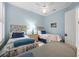 Light-filled bedroom featuring two twin beds, unique headboards, and light blue walls at 5751 Wilena Pl, Sarasota, FL 34238