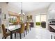 Bright dining room with modern light fixture, sliding glass doors, tile flooring and bright neutral paint at 5751 Wilena Pl, Sarasota, FL 34238