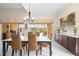Bright dining room with a modern chandelier, sliding glass doors, and tile floors for easy maintenance at 5751 Wilena Pl, Sarasota, FL 34238
