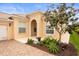 Inviting home with well-kept garden, decorative plants, brick paved entrance, and neutral color scheme at 5751 Wilena Pl, Sarasota, FL 34238