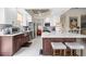 Bright kitchen with large island, stainless appliances, white cabinetry and light countertop spaces at 5751 Wilena Pl, Sarasota, FL 34238