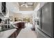 Spacious kitchen with stainless steel appliances, large island, and convenient access to the dining area at 5751 Wilena Pl, Sarasota, FL 34238