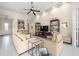 Bright living room featuring neutral tones, ceiling fan, and built-in shelving for decorative display at 5751 Wilena Pl, Sarasota, FL 34238