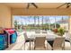 Relaxing covered patio with dining set with view of screened-in pool and lake at 5751 Wilena Pl, Sarasota, FL 34238