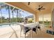 Spacious covered patio next to screened-in pool offering comfortable seating and a scenic view of lake at 5751 Wilena Pl, Sarasota, FL 34238