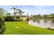 Scenic view of pond with bridge and palm trees offering a tranquil and picturesque setting at 5751 Wilena Pl, Sarasota, FL 34238