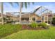 Screened-in pool area featuring a pool, well-maintained landscaping and tall palm trees for backyard privacy at 5751 Wilena Pl, Sarasota, FL 34238