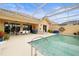 Inviting screened-in pool with spacious patio, sunbathing chairs and view into the covered patio with dining at 5751 Wilena Pl, Sarasota, FL 34238