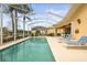 Beautiful screened pool offering privacy, lush landscaping, and a serene view of the community and the lake at 5751 Wilena Pl, Sarasota, FL 34238