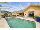 Relaxing screened-in pool with patio, comfortable seating, and beautifully maintained landscape for outdoor enjoyment at 5751 Wilena Pl, Sarasota, FL 34238