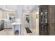 Hallway leading to the kitchen featuring modern countertops, stainless steel appliances, and beautiful wood floors at 5826 David Blvd, Port Charlotte, FL 33981