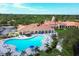 Aerial view of the community pool, clubhouse, and surrounding landscaping at 5881 Girona Pl, Sarasota, FL 34238