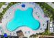 Aerial view of pool, chairs, and umbrellas at 5881 Girona Pl, Sarasota, FL 34238