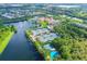 Beautiful aerial view featuring tennis courts, a basketball court, lake, and clubhouse with pool at 5881 Girona Pl, Sarasota, FL 34238
