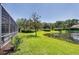 Expansive backyard with lush greenery and a serene lake view, offering a peaceful outdoor setting at 5881 Girona Pl, Sarasota, FL 34238