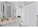 Bright bathroom featuring a large mirror and shower and tub combination at 5881 Girona Pl, Sarasota, FL 34238