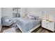 Bright bedroom with white trim, wood floors, and a matching chair and ottoman at 5881 Girona Pl, Sarasota, FL 34238