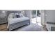 This bedroom features a gray wood slat bed frame and access to a screened outdoor space at 5881 Girona Pl, Sarasota, FL 34238