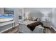 This bedroom features a white wood bed frame, wood floors, and a beach themed painting at 5881 Girona Pl, Sarasota, FL 34238