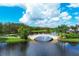 Picturesque bridge over a serene lake surrounded by lush landscape at 5881 Girona Pl, Sarasota, FL 34238