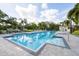 Community pool with clean blue water, mature landscaping, and plenty of lounge chairs for residents to enjoy at 5881 Girona Pl, Sarasota, FL 34238