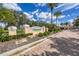 Welcome to Village Walk, a beautiful community entrance with lush landscaping and inviting architecture at 5881 Girona Pl, Sarasota, FL 34238
