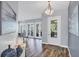Bright foyer with wood-look floors, decorative lighting, and neutral walls that create a welcoming atmosphere at 5881 Girona Pl, Sarasota, FL 34238