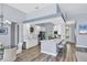 Open kitchen with a white countertop island, bar stools, dining area and recessed lighting at 5881 Girona Pl, Sarasota, FL 34238