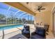 Screened lanai with pool, ceiling fan, and comfortable seating offers a relaxing outdoor space with a view at 5881 Girona Pl, Sarasota, FL 34238