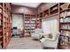 Cozy library with built in bookshelves and comfortable seating at 5881 Girona Pl, Sarasota, FL 34238