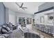 Spacious living room featuring vaulted ceiling, bar seating, and sliding glass doors to the patio at 5881 Girona Pl, Sarasota, FL 34238
