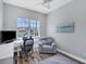 Bright office with a large window overlooking a pool area at 5881 Girona Pl, Sarasota, FL 34238