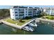 Aerial view of condo building with a private boat dock at 600 Sutton Pl # B305, Longboat Key, FL 34228