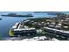 Aerial view showcasing the condos with a pool, tennis court, and the surrounding waterways at 600 Sutton Pl # B305, Longboat Key, FL 34228