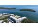 Aerial view of complex near the water featuring a pool and boat dock at 600 Sutton Pl # B305, Longboat Key, FL 34228